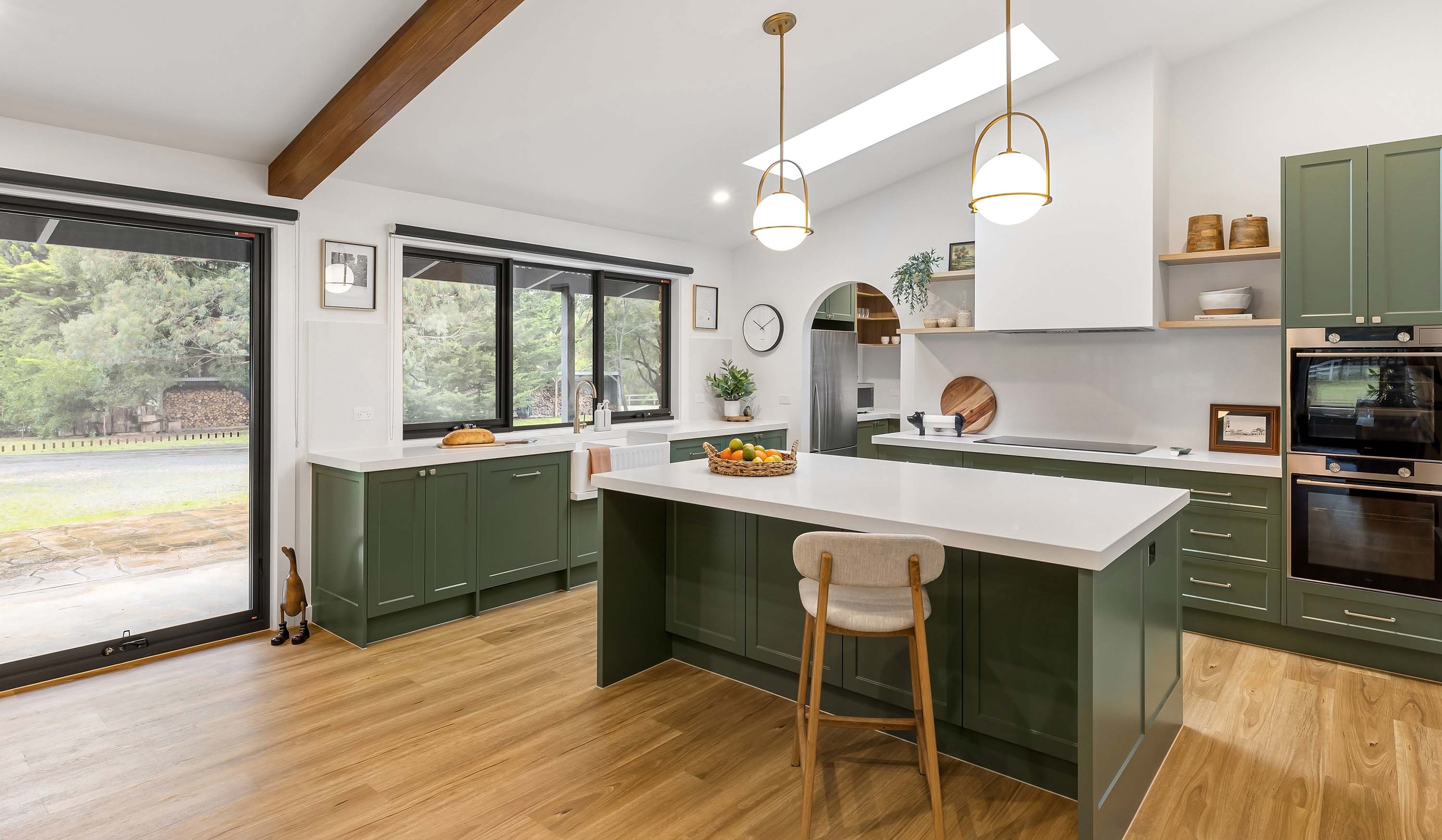 kitchen with green cabinets and white walls